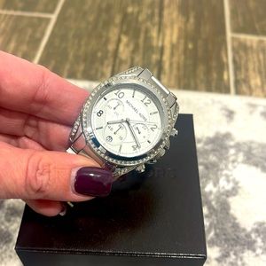 Silver watch by Michael Kors.